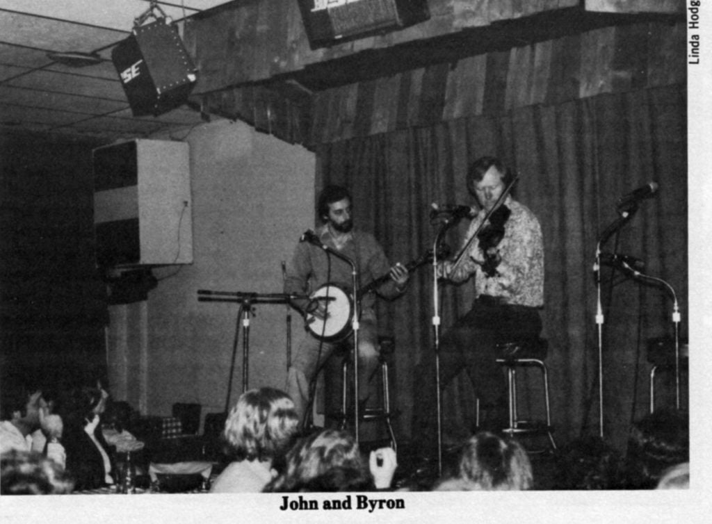 John and Byron singing on stage