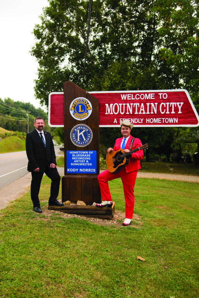 Mayor Kevin Parsons with Kody Norris at the Mountain City highway sign. Photo by Tia Snyder-Thomas